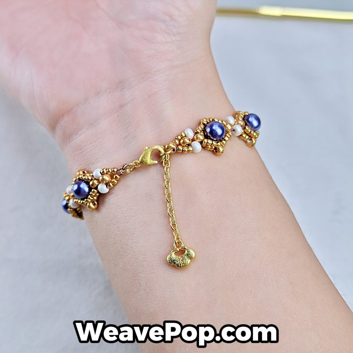 gold pearl beaded bracelet B043 – purple design – bracelet worn close-up