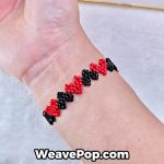 heart seed bead bracelet B046 – red and black design worn on wrist
