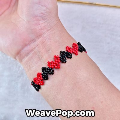heart seed bead bracelet B046 – red and black design worn on wrist