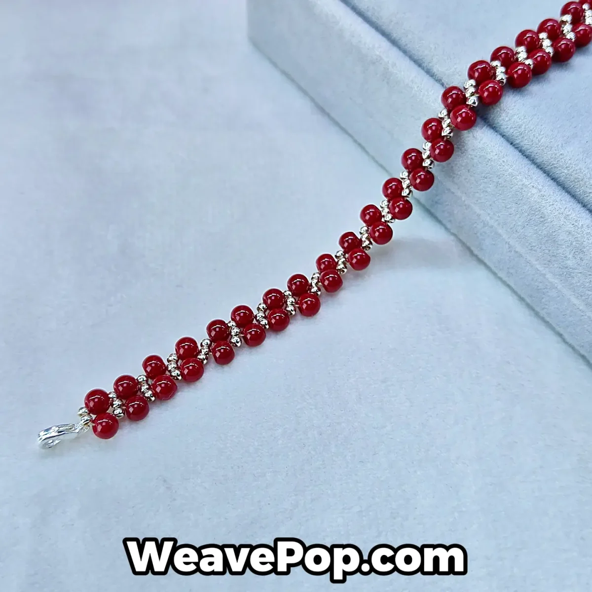 B054 cinnabar red bicone bead bracelet flat lay