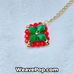 Close-up detail of red and green beaded Christmas earrings – E005