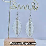 white feather beaded earrings hanging display e006