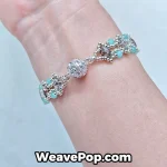 Aqua and silver crystal bead bracelet with lace-style structure worn on wrist B062