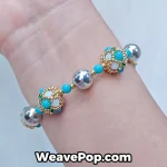 Light blue wide woven beaded cuff bracelet worn on wrist B065