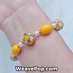 Yellow wide woven beaded cuff bracelet worn on wrist B065
