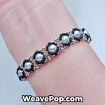 Black pearl beaded bracelet worn on wrist B066