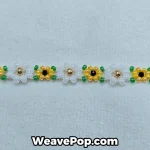 Detail of daisy bead bracelet with white petals and yellow center