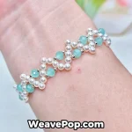 Cross pearl bracelet worn on wrist – lake blue