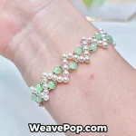 Cross pearl bracelet worn on wrist – green