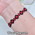 Red beaded bracelet with geometric diamond pattern