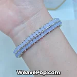 Close-up of the B076 purple beaded bracelet with crystal pearls on a model
