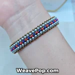 Close-up view of the bronze woven bead bracelet on a woman's arm