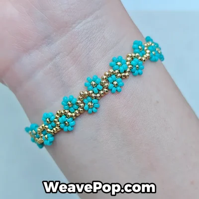 Woman wearing a dainty cyan floral Miyuki bracelet for a summer beach look