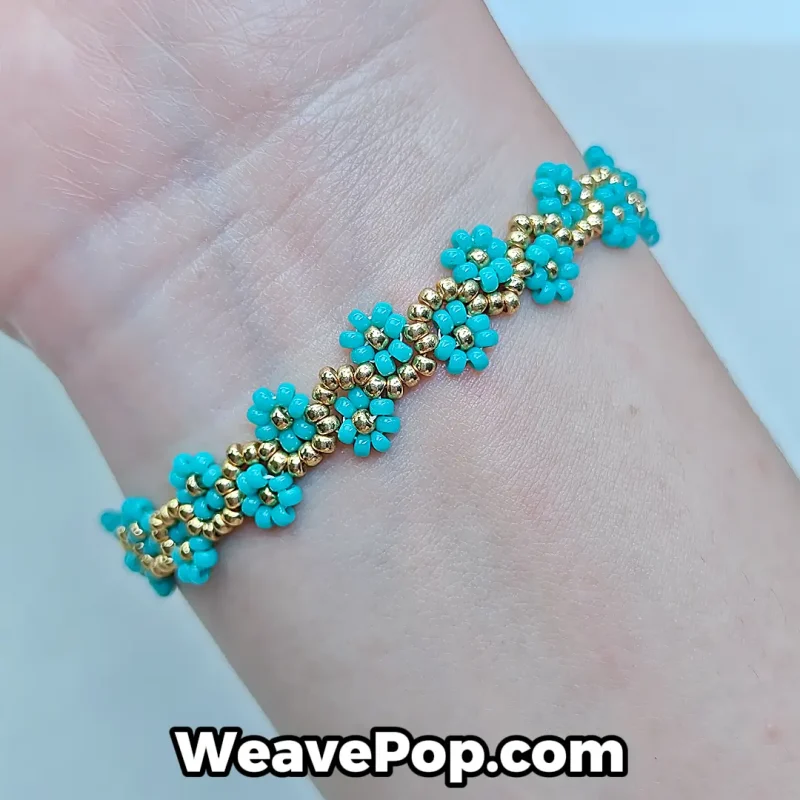 Woman wearing a dainty cyan floral Miyuki bracelet for a summer beach look