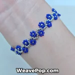 Sophisticated dark blue flower friendship bracelet B077 worn on a wrist
