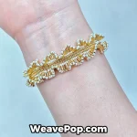 A woman wearing the B079 architectural ruffle bracelet, highlighting its 3D woven texture under natural light