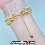 Close-up of the B079 gold and white woven bracelet on a wrist, styled with elegant vintage attire.