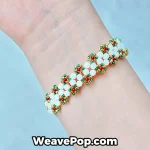 Handmade daisy flower bracelet worn on wrist with elegant white floral beadwork