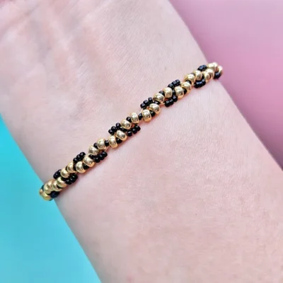 Handcrafted gold and black twisted bead bracelet worn on wrist — B082 Bead Bracelet Kit by WeavePop